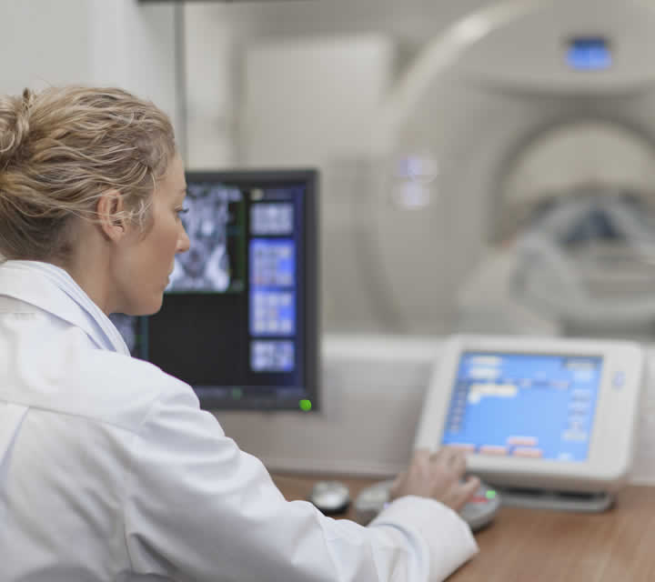 Radiology technician readies CT machine for scanning