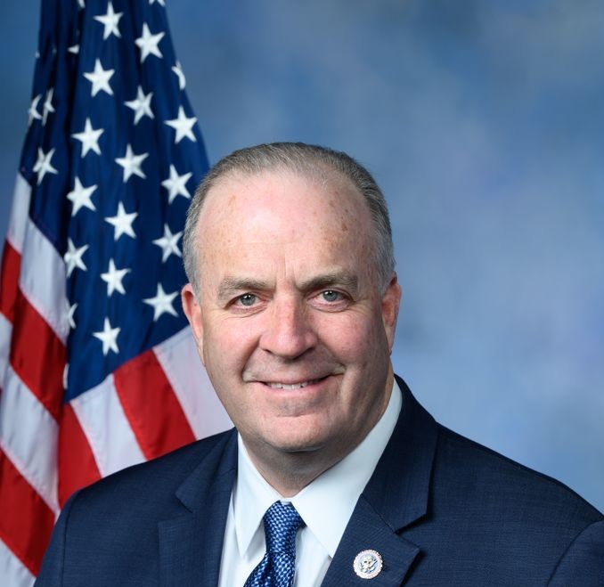 Congressman Dan Kildee poses in front of American Flag